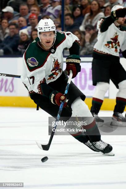 Nick Bjugstad of the Arizona Coyotes controls the puck during the game against the Columbus Blue Jackets at Nationwide Arena on November 16, 2023 in...