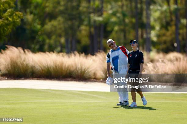 Charley Hull of England and her caddie Adam Woodward walk the second hole during the second round of the CME Group Tour Championship at Tiburon Golf...