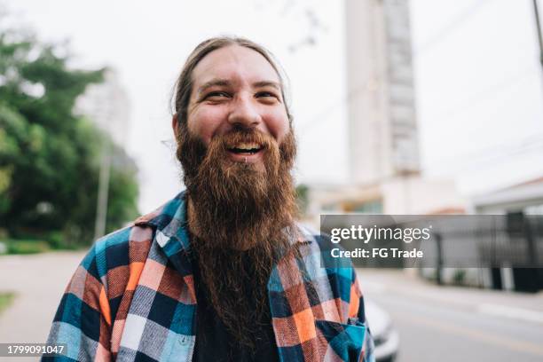 portrait of a mid adult man in the street - emo guy stock pictures, royalty-free photos & images