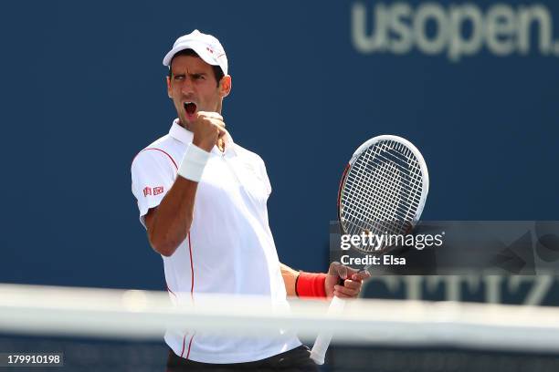 Novak Djokovic of Serbia celebrates winning the second set during his men's singles semifinal match against Stanislas Wawrinka of Switzerland on Day...