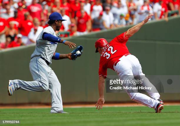 Hanley Ramirez of the Los Angeles Dodgers reaches to tag out Jay Bruce of the Cincinnati Reds in a run down in the bottom of the first inning at...