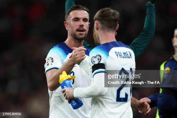 Jordan Henderson and Cole Palmer of England shake hands as Cole Palmer enters the pitch as a substitute during the UEFA EURO 2024 European qualifier...