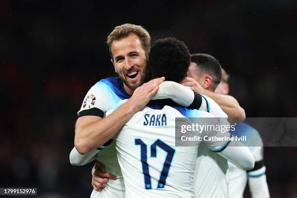 Harry Kane of England celebrates with teammates Bukayo Saka and Phil Foden after scoring the team's second goal during the UEFA EURO 2024 European...