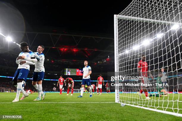 Bukayo Saka and Phil Foden of England celebrate their side's second goal scored by Harry Kane of England during the UEFA EURO 2024 European qualifier...