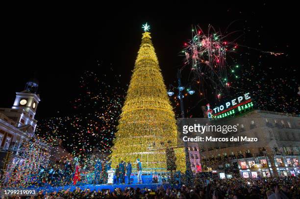 View of the Christmas tree at Puerta del Sol with fireworks and confetti as the Christmas lights are turned on. More than 12,000 people have gathered...