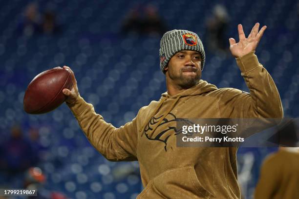 Russell Wilson of the Denver Broncos warms up prior to an NFL football game against the Buffalo Bills at Highmark Stadium on November 13, 2023 in...