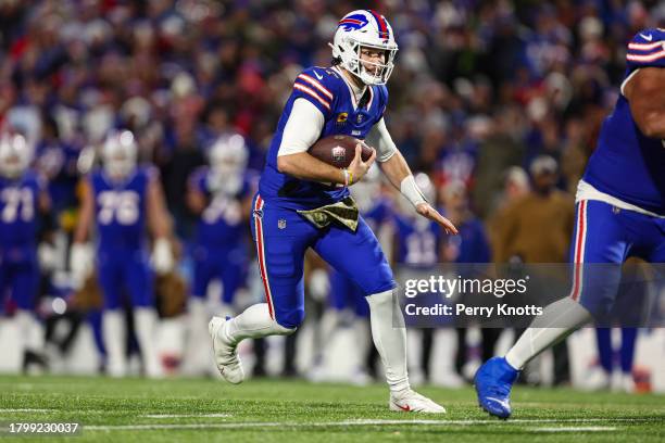 Josh Allen of the Buffalo Bills runs the ball during an NFL football game against the Denver Broncos at Highmark Stadium on November 13, 2023 in...