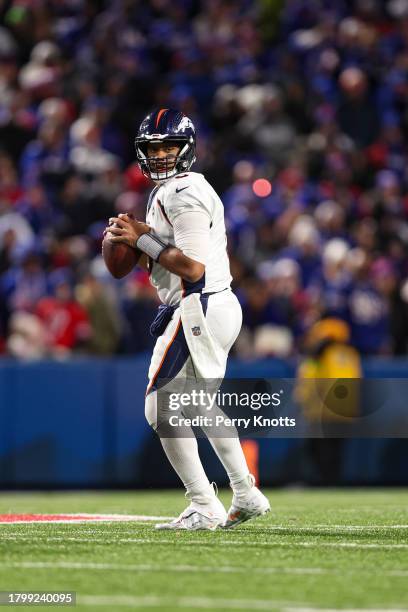 Russell Wilson of the Denver Broncos drops back to pass during an NFL football game against the Buffalo Bills at Highmark Stadium on November 13,...