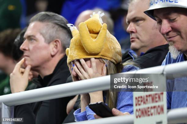 Detroit fan wearing a turkey hat holds her hands over her eyes in dejection in the closing minutes of the fourth quarter during a traditional...