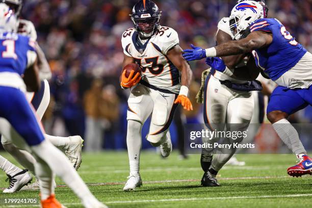 Javonte Williams of the Denver Broncos runs the ball during an NFL football game against the Buffalo Bills at Highmark Stadium on November 13, 2023...