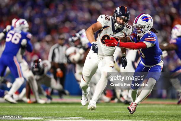 Adam Trautman of the Denver Broncos is covered by Damar Hamlin of the Buffalo Bills during an NFL football game at Highmark Stadium on November 13,...