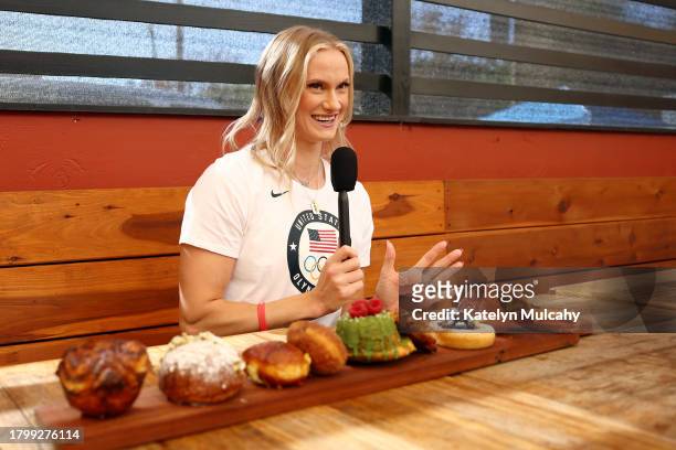Olympian Katie Moon of Lakewood, Ohio, answers media questions at a Parisian cafe during the Team USA Road to Paris Bus Tour on November 17, 2023 in...