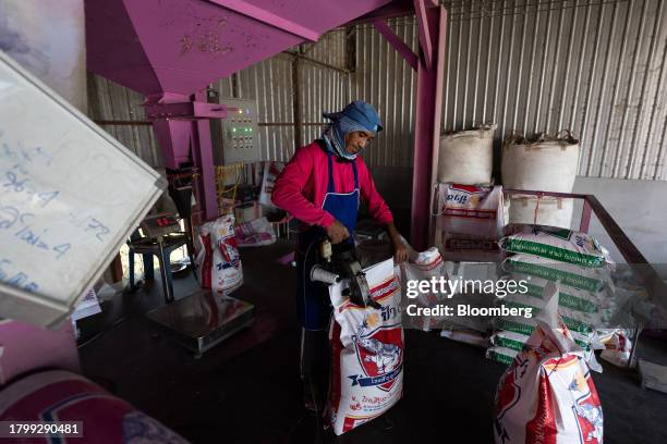 Worker seals a sack of rice inside a mill in Kalasin province, Thailand, on Monday, Nov. 20, 2023. Limited supply from Vietnam has led to buyers such...