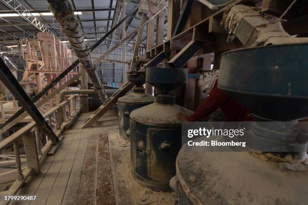 Worker checks machinery inside a rice mill in Kalasin province, Thailand, on Monday, Nov. 20, 2023. Limited supply from Vietnam has led to buyers...