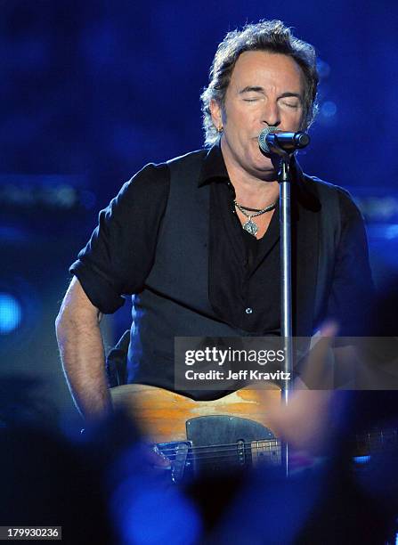 Musician Bruce Springsteen and the E Street Band perform at the Bridgestone halftime show during Super Bowl XLIII between the Arizona Cardinals and...