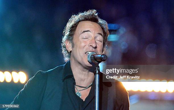 Musician Bruce Springsteen and the E Street Band perform at the Bridgestone halftime show during Super Bowl XLIII between the Arizona Cardinals and...