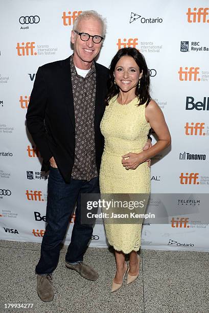 Actress Julia Louis-Dreyfus and Brad Hall arrive at the "Enough Said" premiere during the 2013 Toronto International Film Festival at The Elgin on...