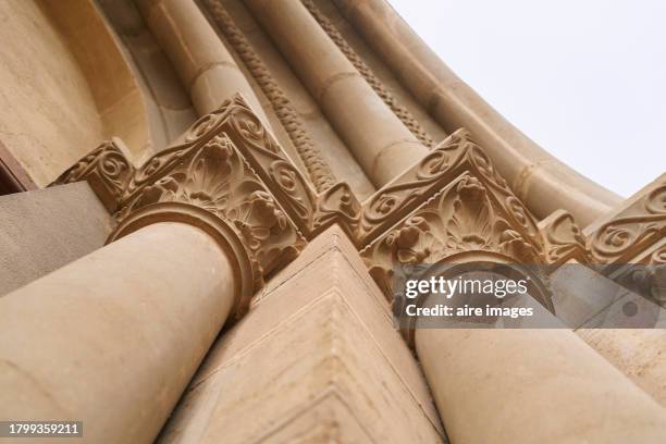 san martin moncayo, aragon, spain - january 9, 2022: two vertical columns of greek style, yellowish color, with curves, made of concrete, seen from a low angle. - ionisch stock-fotos und bilder