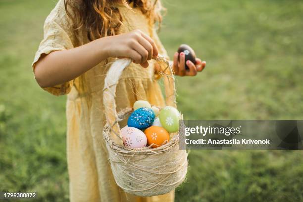 multi-ethnic girl searching for easter eggs. - easter basket - fotografias e filmes do acervo