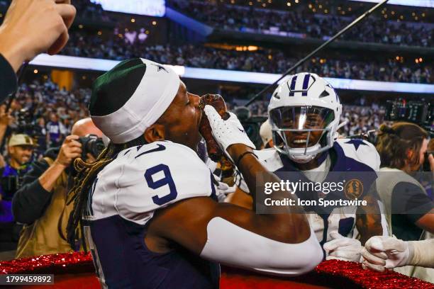 Dallas Cowboys wide receiver KaVontae Turpin jumps into the Salvation Army Kettle and eats a turkey leg during the game between the Dallas Cowboys...