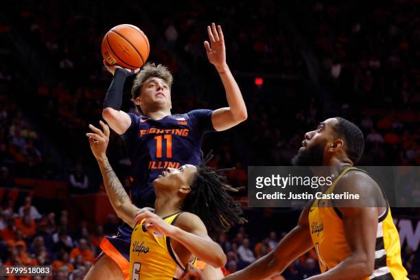 Niccolo Moretti of the Illinois Fighting Illini takes a shot over Darius DeAveiro of the Valparaiso Crusaders during the first half at State Farm...