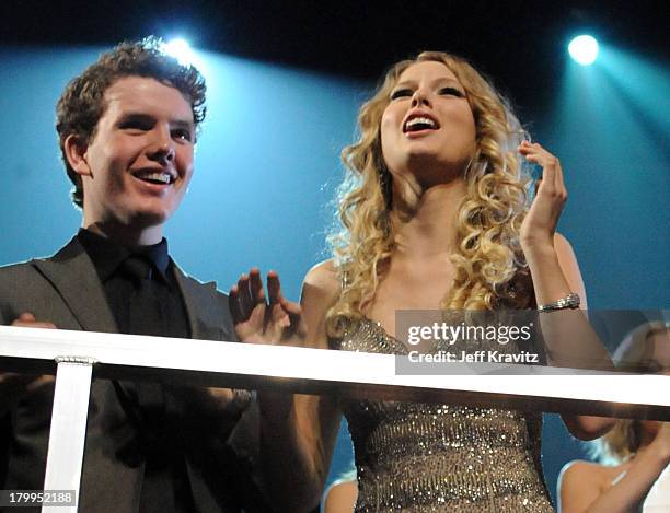 Musician Taylor Swift and Austin Swift react after winning an award during the 2009 CMT Music Awards at the Sommet Center on June 16, 2009 in...