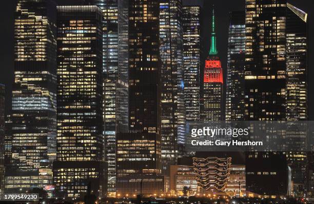 The Empire State Building is lit in its holiday colors of red and green to mark the opening night of the Radio City Rockettes' Christmas Spectacular...