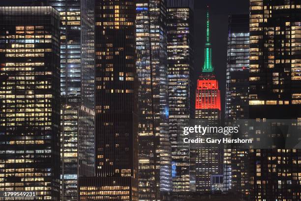 The Empire State Building is lit in its holiday colors of red and green to mark the opening night of the Radio City Rockettes' Christmas Spectacular...