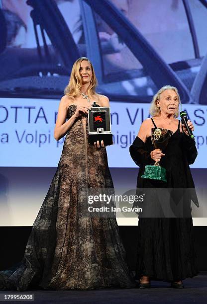 Actress Elena Cotta holds the Coppa Volpi award for best actress in 'Via Castellana Bandiera' before receiving a Jaeger-LeCoultre engraved Reverso...