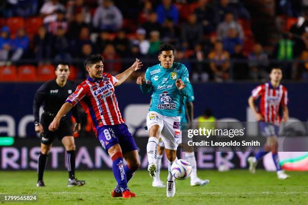 Javier Guemez of Atletico San Luis competes for the ball with Lucas Romero of Leon during the Play-in match between Atletico San Luis and Leon as...