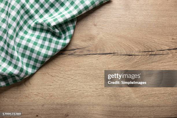 green checkered kitchen tablecloth on wooden table. - chopping board background stock pictures, royalty-free photos & images