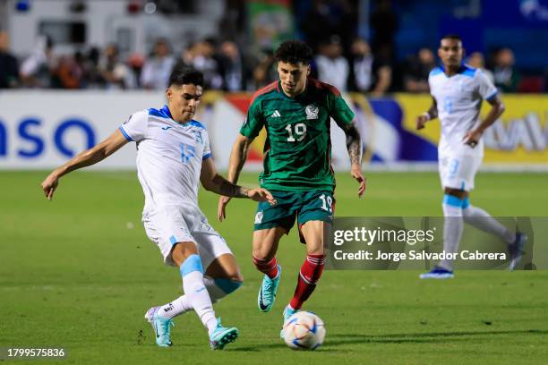 Luis Palma of Honduras battles for possession with Jorge Sanchez of Mexico during the CONCACAF Nations League quarterfinals first leg match between...