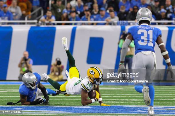 Green Bay Packers wide receiver Malik Heath is tackled by Detroit Lions cornerback Cameron Sutton while Detroit Lions safety Kerby Joseph follows the...