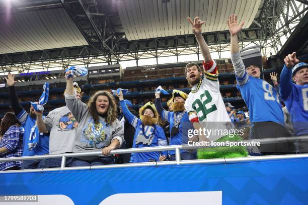 Detroit and Green Bay fans cheer during a traditional Thanksgiving Day NFL football game between the Green Bay Packers and the Detroit Lions on...