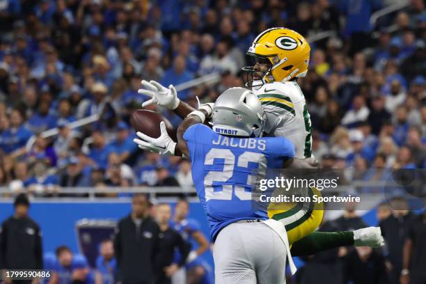 Green Bay Packers wide receiver Romeo Doubs leaps to catch a pass against Detroit Lions cornerback Jerry Jacobs during a traditional Thanksgiving Day...