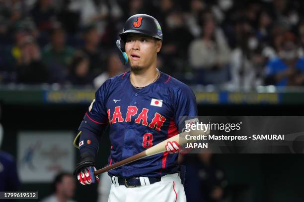 Designated hitter Teruaki Sato of Japan reacts after striking out in the 1st inning during the Asia Professional Baseball Championship game between...