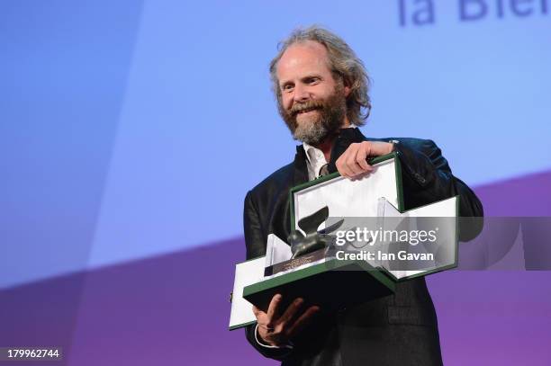 German Director Philip Groning poses with the Special Jury Prize he received for his movie 'Die Frau Des Polizisten' on stage during the Closing...