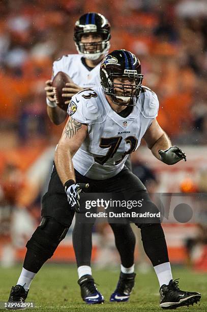 Guard Marshal Yanda of the Baltimore Ravens blocks for quarterback Joe Flacco during the game against the Denver Broncos at Sports Authority Field at...