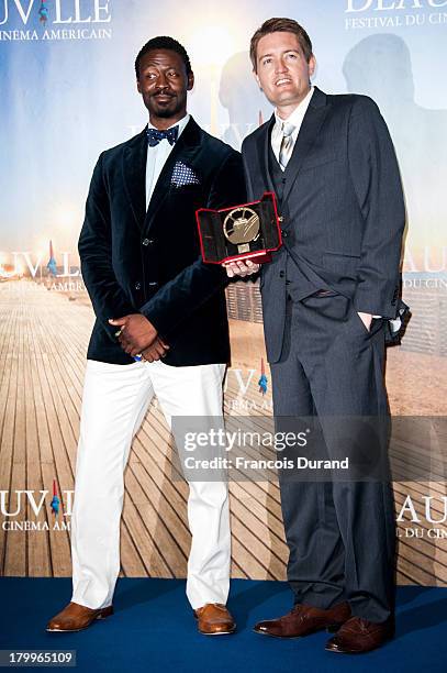 Tishuan Scott and Chris Eska pose with their prize for the film "The retrieval" during the 39th Deauville American Film Festival on September 7, 2013...