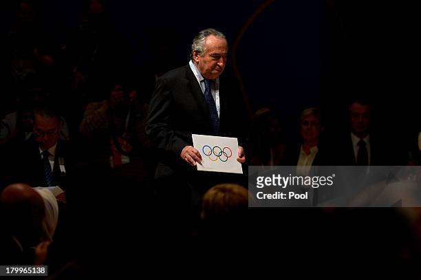 The envelope with the name of the city of Tokyo elected to host the 2020 Summer Olympics is carried to the stage by IOC member Francisco Elizalde...