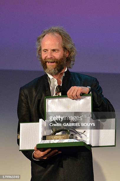 German director Philip Groning poses with the Special Jury Prize he received for his movie "Die Frau Des Polizisten" during the award ceremony of the...
