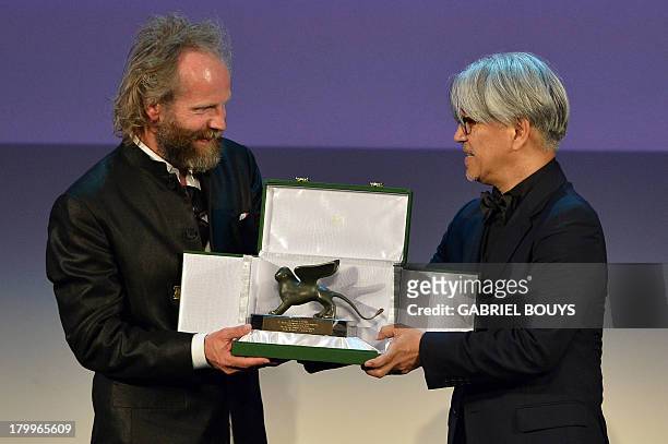 German director Philip Groning poses with the Special Jury Prize he received for his movie "Die Frau Des Polizisten" during the award ceremony of the...