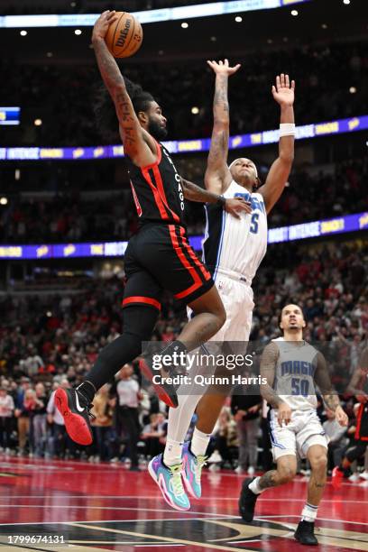 Coby White of the Chicago Bulls is fouled shooting in the second half of an NBA In-Season Tournament against Paolo Banchero of the Orlando Magic at...