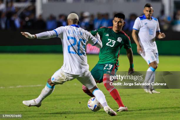 Jesus Gallardo of Mexico battles for possession with Deybi Flores of Honduras during the CONCACAF Nations League quarterfinals first leg match...