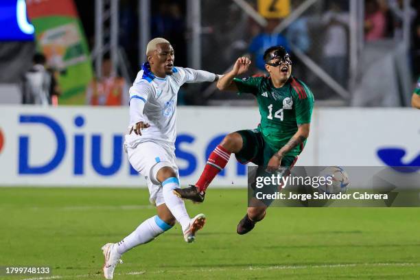 Deybi Flores of Honduras battles for possession with Erick Sanchez of Mexico during the CONCACAF Nations League quarterfinals first leg match between...