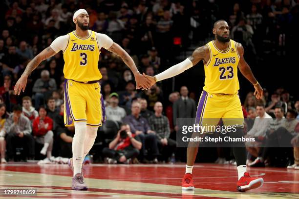 Anthony Davis and LeBron James of the Los Angeles Lakers react after a basket against the Portland Trail Blazers during the fourth quarter at Moda...
