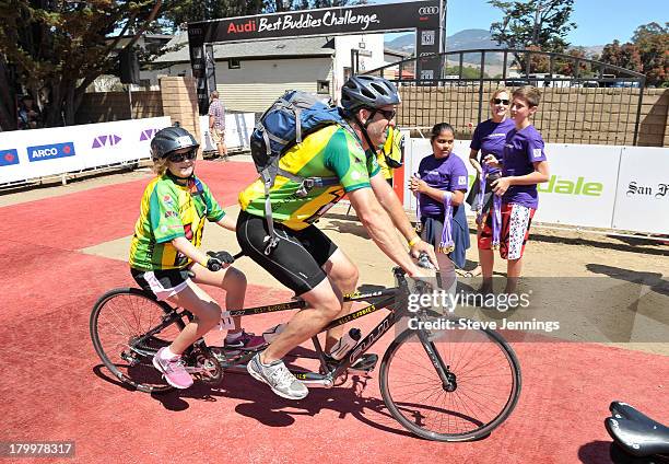 Riders arrive at the finish line of the Best Buddies Challenge: Hearst Castle Ride to Finish at Hearst Castle on September 7, 2013 in San Simeon,...