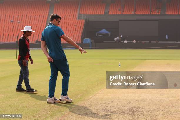 Pat Cummins of Australia inspects the pitch prior to an Australian press conference ahead of the the ICC Men's Cricket World Cup Final 2023 at...