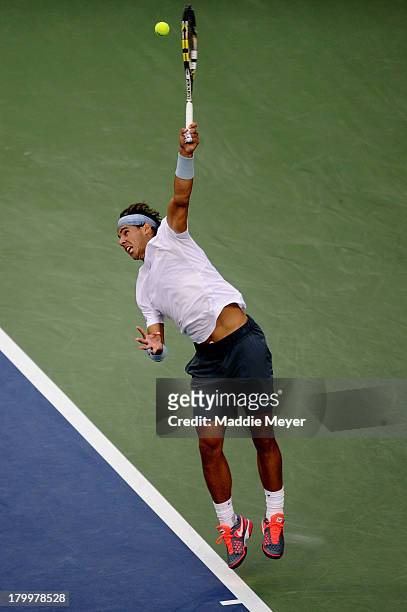 Rafael Nadal of Spain serves during his men's singles semifinal match against Richard Gasquet of France on Day Thirteen of the 2013 US Open at USTA...