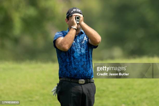 Patrick Reed of the United States measures the distance to the green on hole 2 during the third round of the BNI Indonesian Masters presented by...